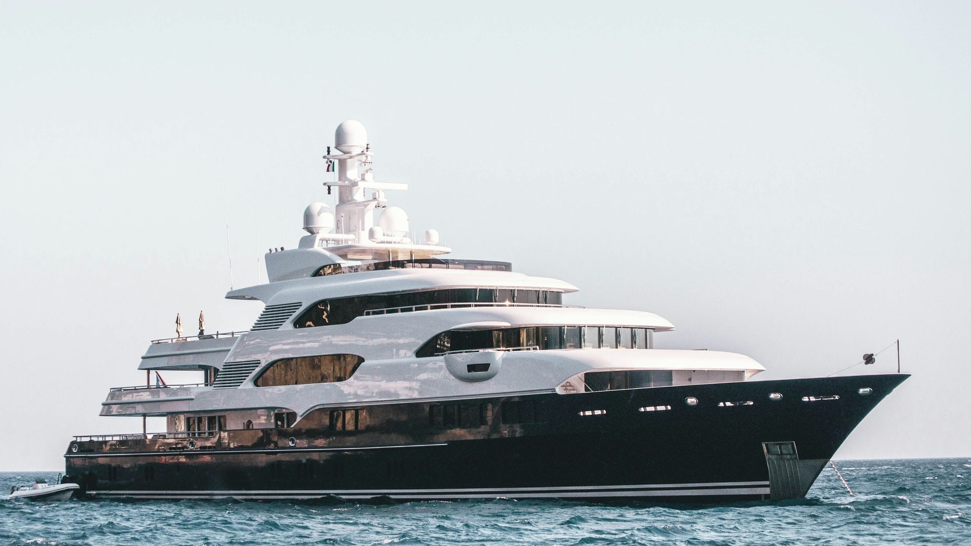 Luxury yacht sailing on the ocean — boat and yacht design services by certified naval architects